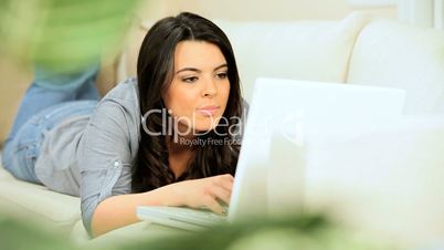 Brunette Girl at Home Using a Laptop