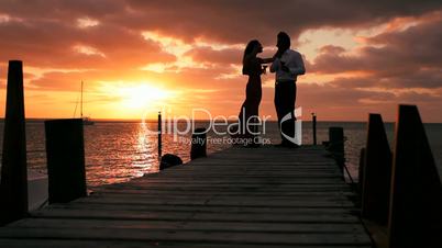 Elegant Couple at Sunset with a Glass of Wine