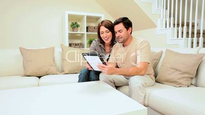 Young Couple With Wireless Tablet at Home