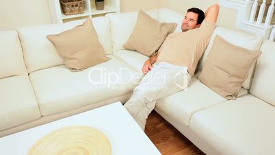 Young Couple Relaxing on Home Sofa