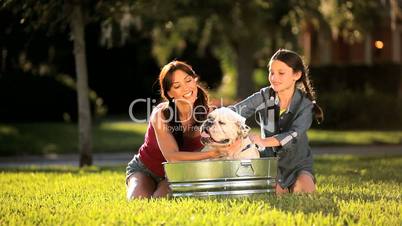 Young Mother & Daughter Bathing Family Bulldog