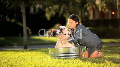 Young Girl Bathing her Pet Bulldog