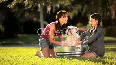 Young Mother & Daughter Bathing Family Bulldog