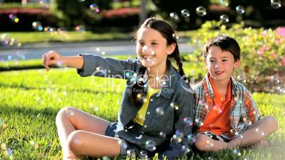 Young Children Surrounded by Play Bubbles