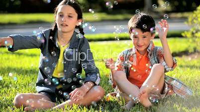 Two Children Outdoors with Play Bubbles