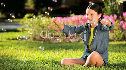 Young Girl Playing Laughing with Soap Bubbles