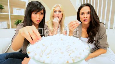 Three Girlfriends Watching Scary Movie with Popcorn