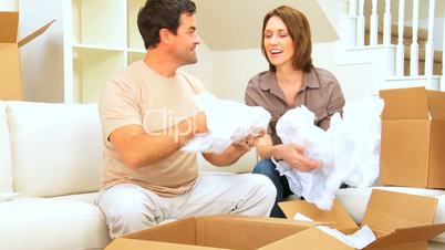 Couple Unpacking Moving Cartons