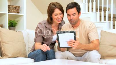 Young Couple With Wireless Tablet at Home