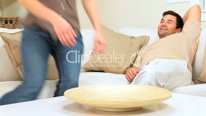 Young Couple Relaxing on Home Sofa