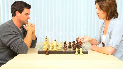 Relaxed Young Couple Playing Chess