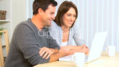 Relaxed Young Couple Using Internet Webchat