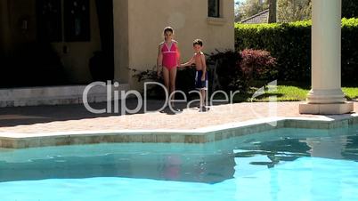 Caucasian Siblings Enjoying the Swimming Pool