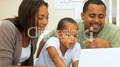 African American Family Viewing a Laptop