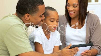 Young Ethnic Family Using Wireless Tablet