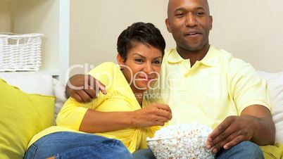 Ethnic Couple Relaxing With a Movie & Popcorn