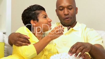 African-American Couple at Home Eating Popcorn