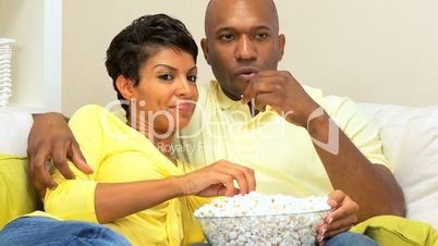 Ethnic Couple Watching Scary Movie with Popcorn