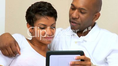 Ethnic Couple Using Wireless Tablet for Webchat