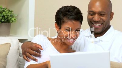 Loving Couple Using Laptop at Home