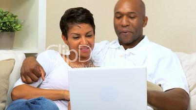 Ethnic Couple Using Laptop for Webchat