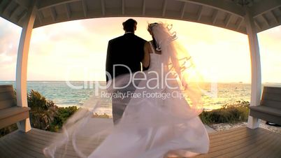 Wide-angle  View of Sunset Wedding Couple