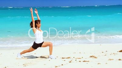 Healthy Female Doing Stretches on the Beach