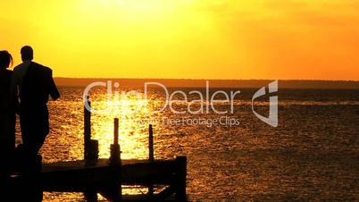 Elegant Couple on Wooden Jetty at Sunset