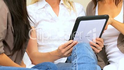 Three Friends in Close-up with Wireless Tablet