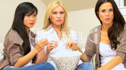 Three Girlfriends Watching Scary Movie with Popcorn