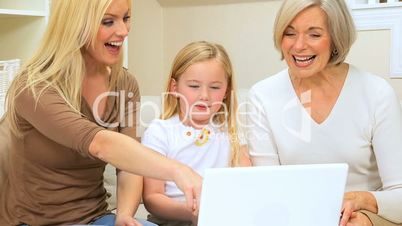 Three Female Generations Using Laptop