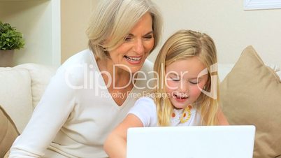 Loving Grandma with Grandchild Playing on Laptop