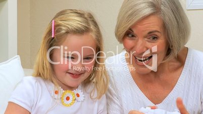 Cute Girl & Grandma Playing on Games Console