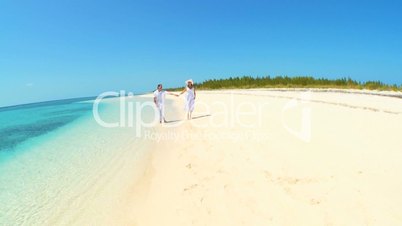 Couple Running in the Shallows Along Tropical Beach
