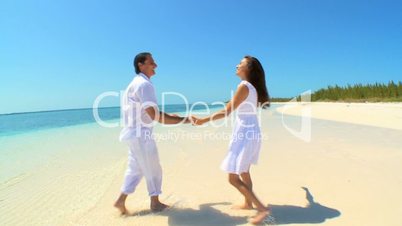Attractive Couple Laughing & Dancing on Luxury Island Vacation