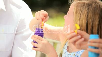 Cute Little Girl in Close-up With Play Bubbles
