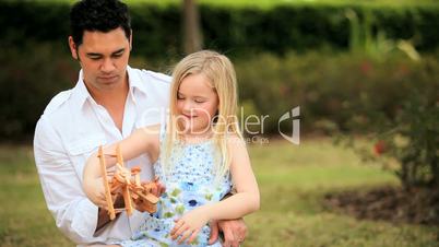 Little Blonde Girl with Asian Father in Park