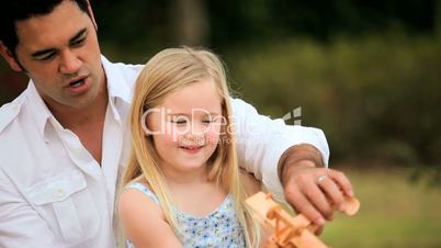 Multi-Ethnic Father & Daughter Playing in Park