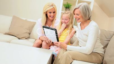 Three Generations of Females Using Wireless Tablet