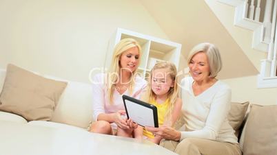 Three Generations Having Fun with Wireless Tablet