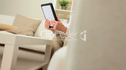 Mature Lady Using Wireless Tablet for Web-chat