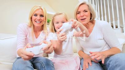 Child Playing on Games Console with Family