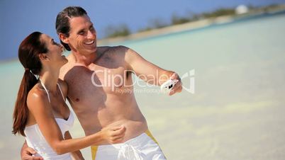 Beach Vacation Couple Laughing with a Camera