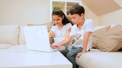 Young Children Playing Games on Laptop