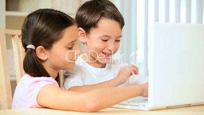 Children Playing on Laptop at Home