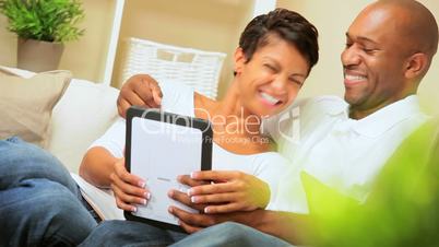 Ethnic Couple Using Wireless Tablet