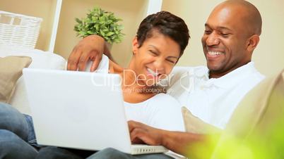 Young African-American Couple Using Laptop at Home