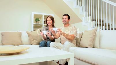 Caucasian Couple Competing on Games Console