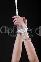 woman hands with beads bind with rope
