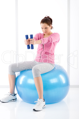 Fitness woman exercise dumbbell ball gym